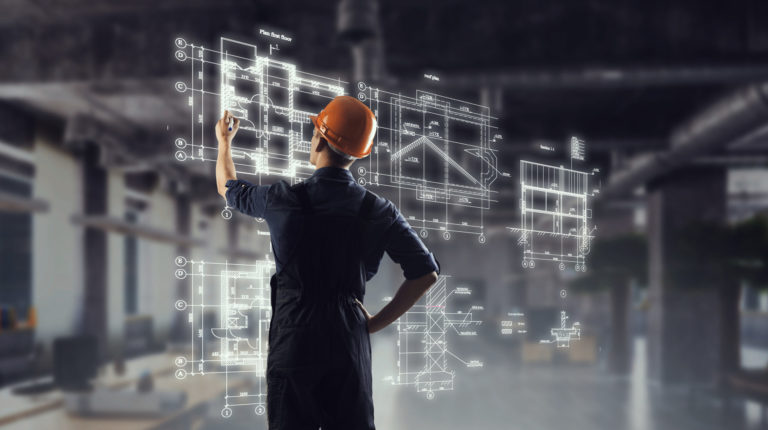 Construction worker using advanced jobsite layout technology with digital building schematics overlaid in a modern worksite.