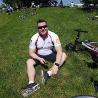 Plexxis cycling team member sitting on grass